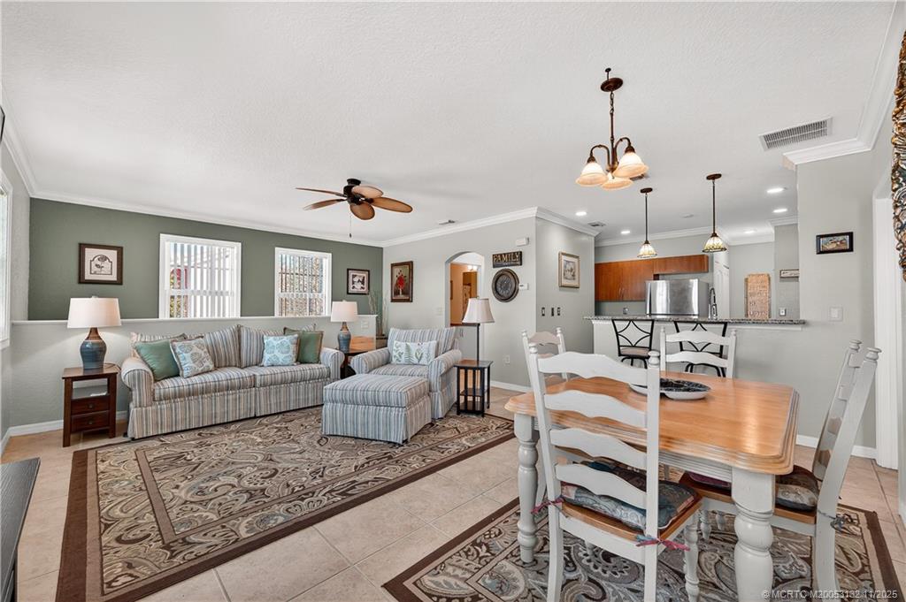 160 Southwest Peacock Boulevard, Unit 31203 Port St. Lucie, FL 34986 - Photo 7 of 43 a living room with furniture and kitchen view