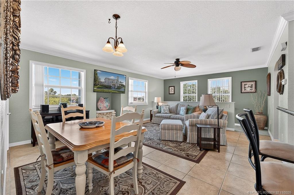 160 Southwest Peacock Boulevard, Unit 31203 Port St. Lucie, FL 34986 - Photo 8 of 43 a view of a dining room with furniture window and wooden floor