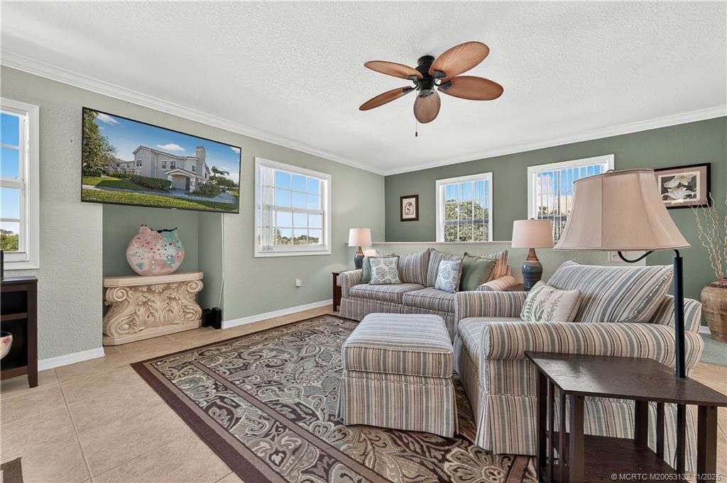 160 Southwest Peacock Boulevard, Unit 31203 Port St. Lucie, FL 34986 - Photo 9 of 43 a living room with furniture and a rug