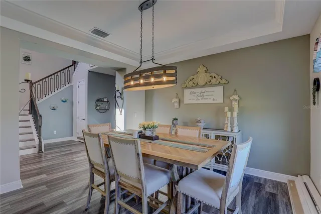 a living room with furniture a flat screen tv and a large window