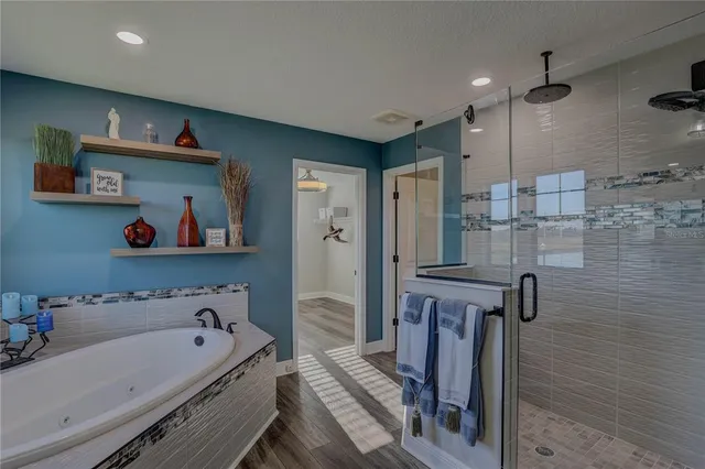 a bedroom with a bed a flat screen tv and dresser