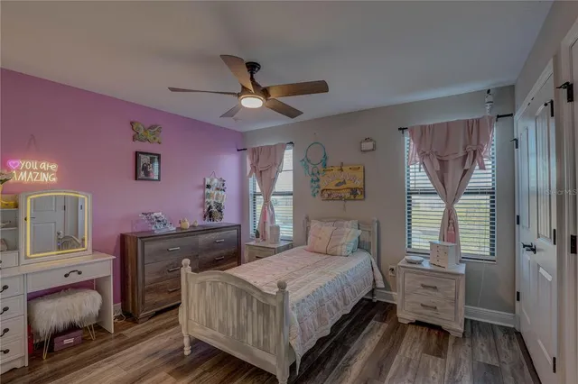 a view of a hallway to a livingroom with furniture wooden floor and window