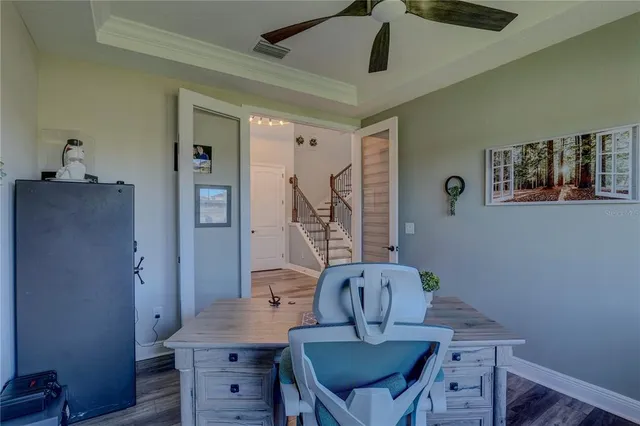 a dining room with furniture a chandelier and wooden floor