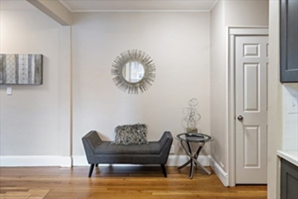 52 Strathmore Road, Unit 25 Boston, MA 02135 - Photo 3 of 12 a view of a livingroom with furniture and wooden floor