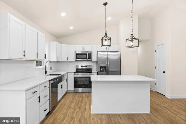 a kitchen with stainless steel appliances and white cabinets