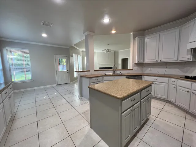 a kitchen that has a sink a stove cabinets and a counter top space
