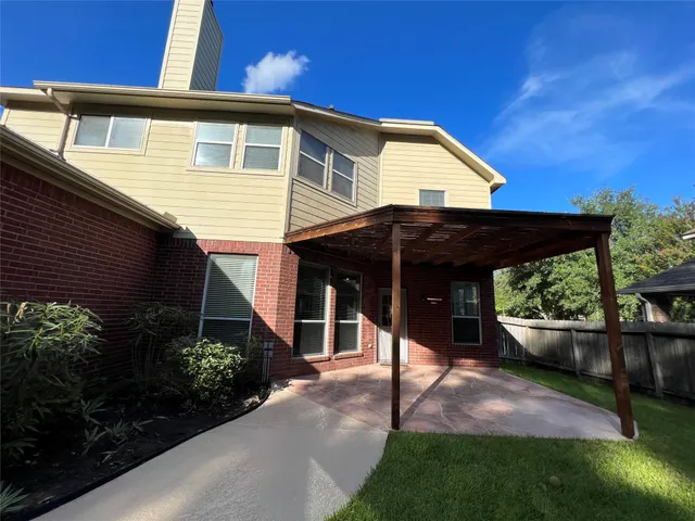 a view of house with backyard