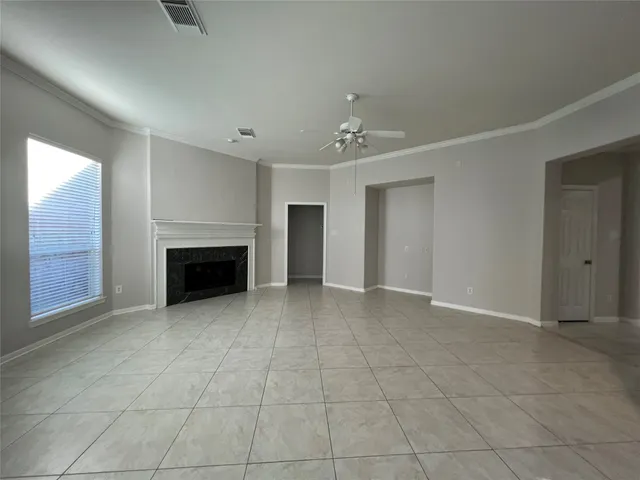 a view of empty room with a fireplace