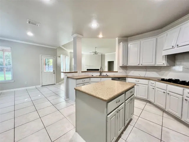 a kitchen with a sink a stove a microwave and cabinets