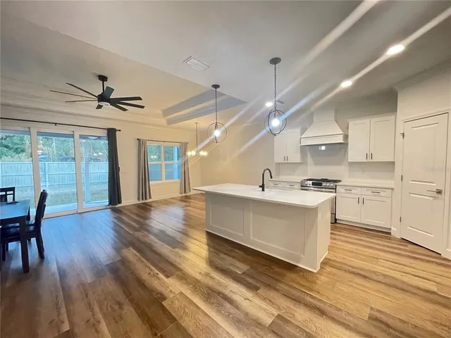 a view of kitchen with cabinets and wooden floor