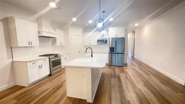 a kitchen with a sink stainless steel appliances and cabinets