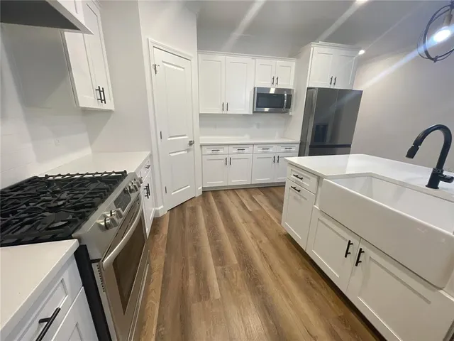 a kitchen with a sink stove and refrigerator