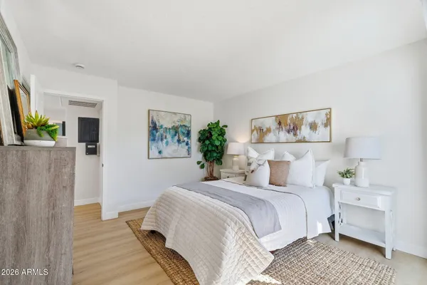 a bedroom with a bed and a desk