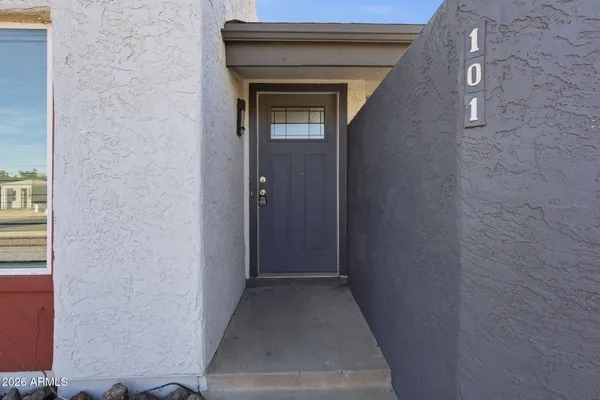 a view of a hallway with wooden floor and a door