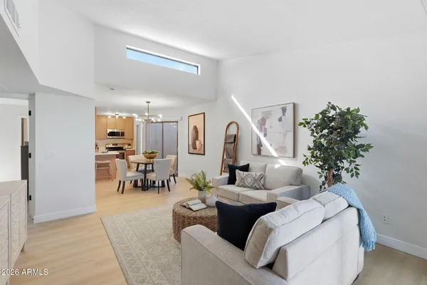 a living room with furniture and a potted plant