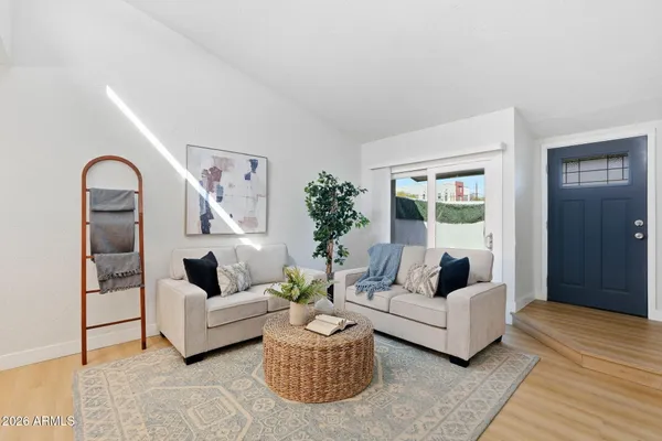 a living room with furniture and a wooden floor