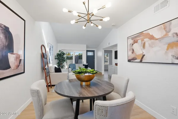 a view of a dining room with furniture and a potted plant