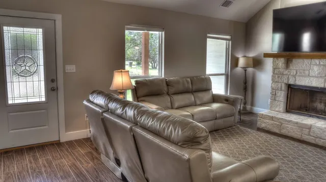 a living room with furniture and a fireplace
