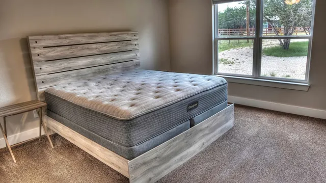 a bedroom with a bed and a window