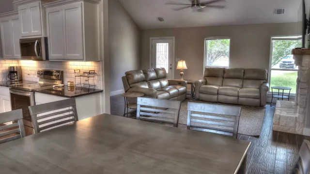 a living room with furniture and wooden floor