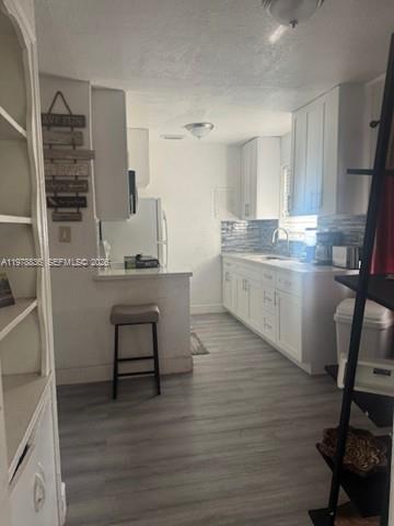 850 Northwest 84th Street Miami, FL 33150 - Photo 4 of 10 a kitchen with a sink cabinets and wooden floor