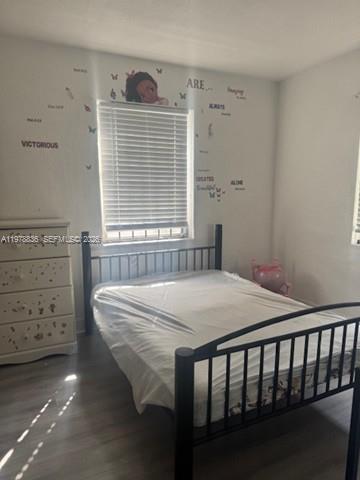 850 Northwest 84th Street Miami, FL 33150 - Photo 6 of 10 a bed sitting in a bedroom next to a window
