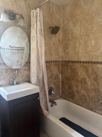 850 Northwest 84th Street Miami, FL 33150 - Photo 7 of 10 a bathroom with a sink a mirror and a shower
