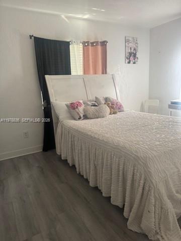 850 Northwest 84th Street Miami, FL 33150 - Photo 8 of 10 a bedroom with a bed and a window