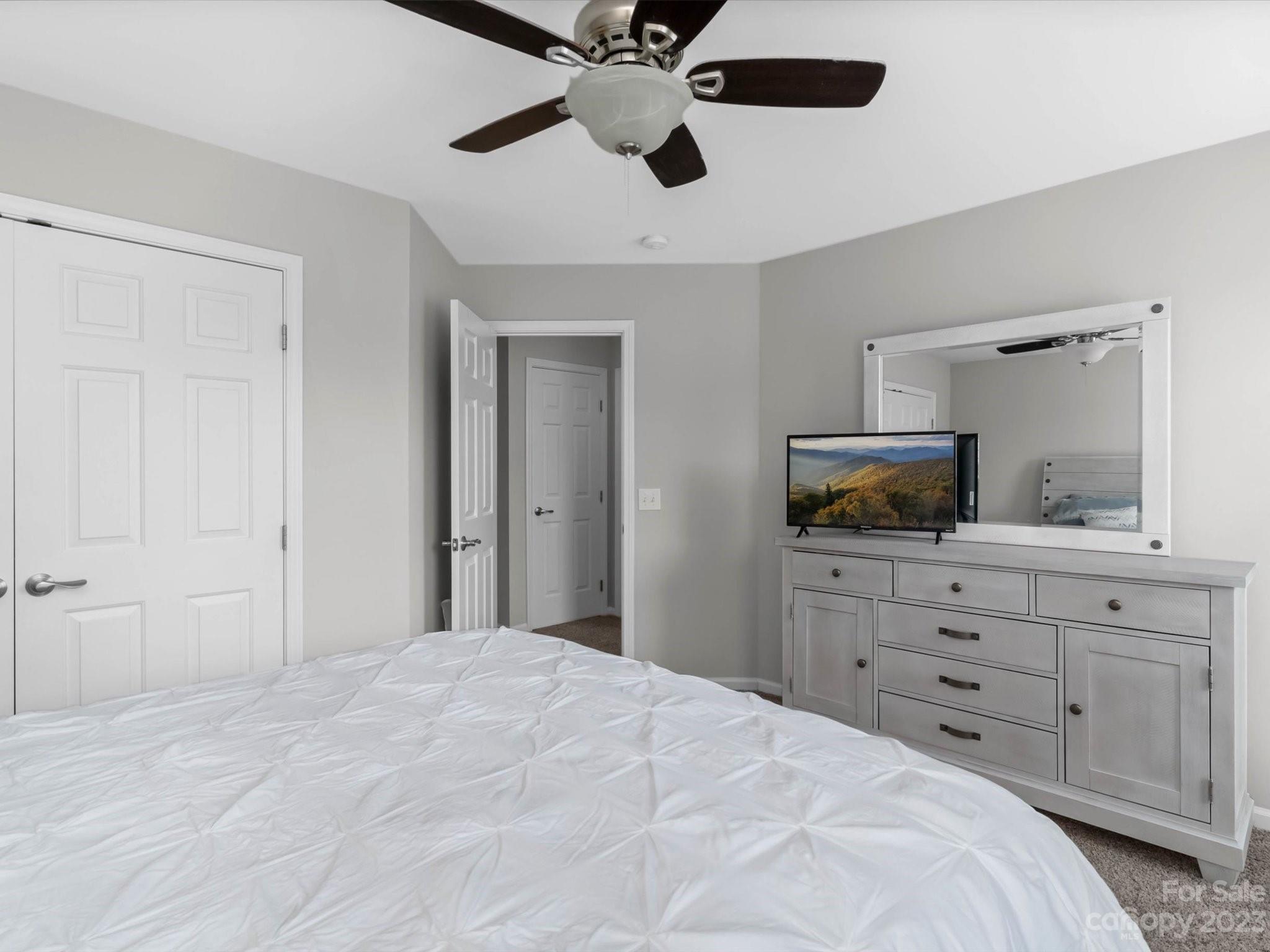 7902 Mariners Pointe Circle Denver, NC 28037 - Photo 28 of 42 a bedroom with a bed and a flat screen tv