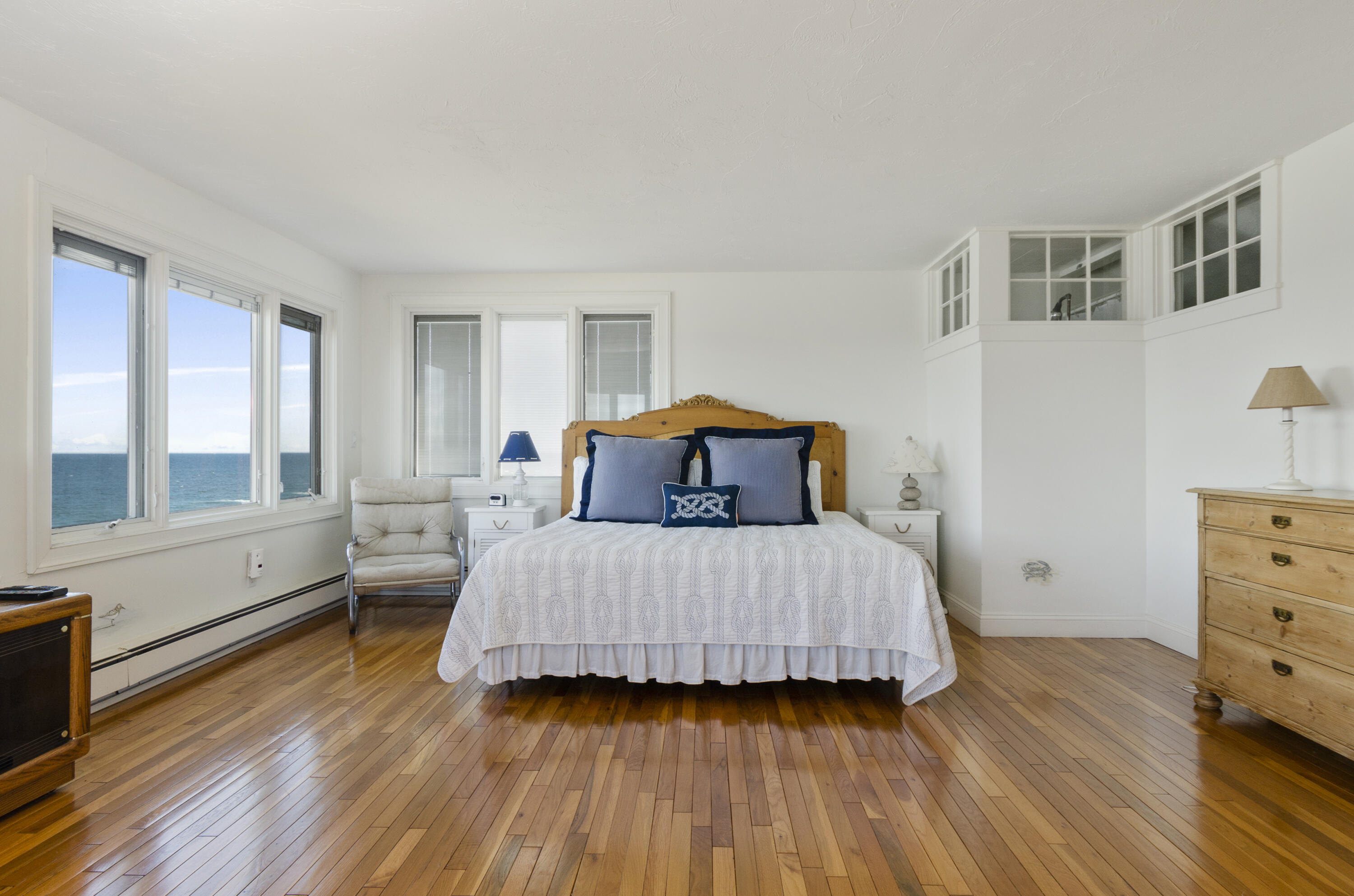 96 Shore Drive Dennis, MA 02638 - Photo 15 of 37 a bedroom with a bed and wooden floor