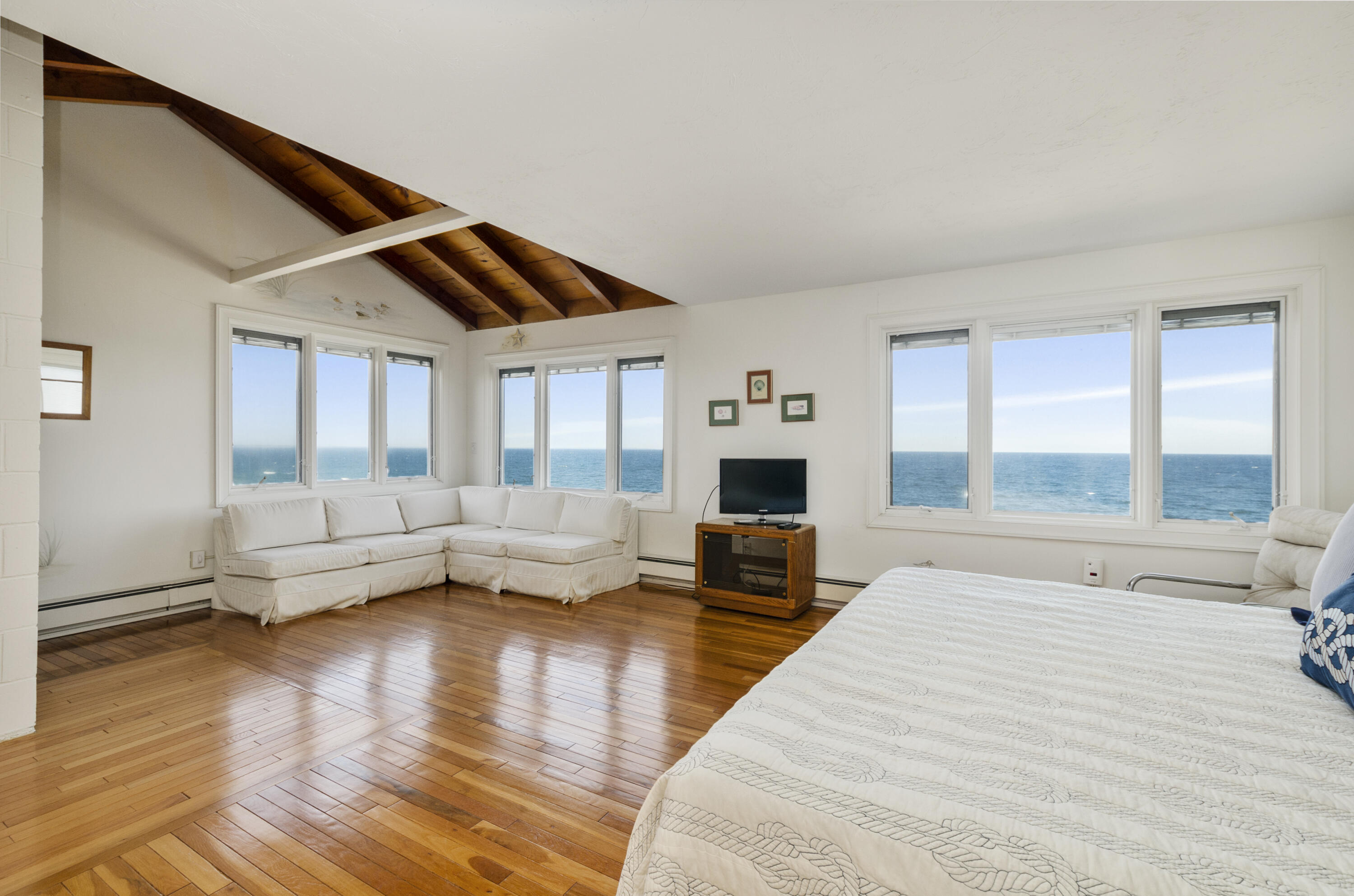 96 Shore Drive Dennis, MA 02638 - Photo 16 of 37 a bedroom with furniture and a large window