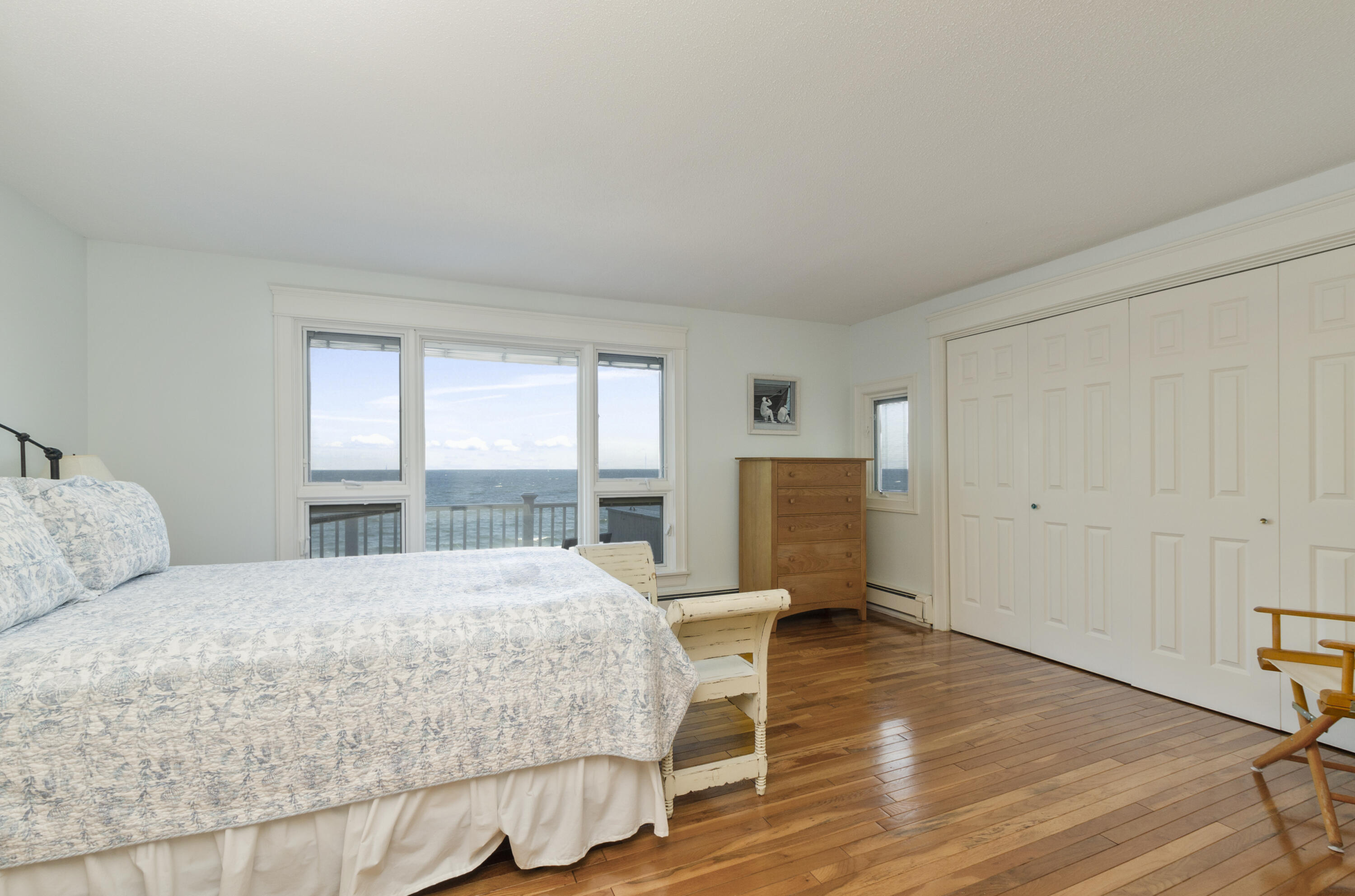 96 Shore Drive Dennis, MA 02638 - Photo 18 of 37 a bedroom with a bed large window and walk in closet