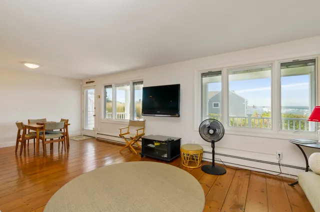 a living room with granite countertop furniture and a wooden floor