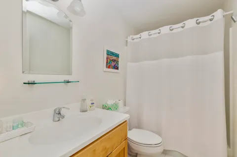 a bedroom with two beds and a window with outer view