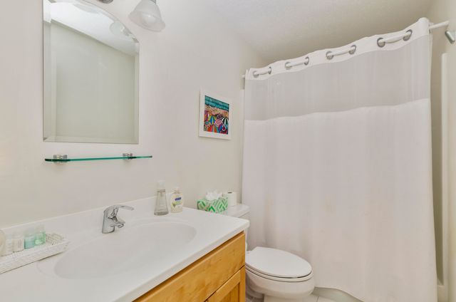 a bedroom with two beds and a window with outer view