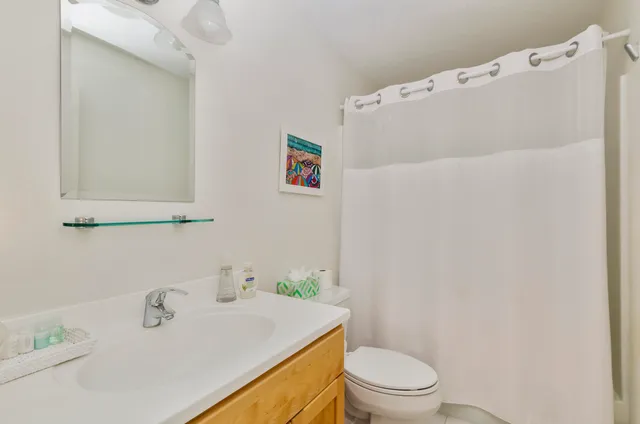 a bedroom with two beds and a window with outer view