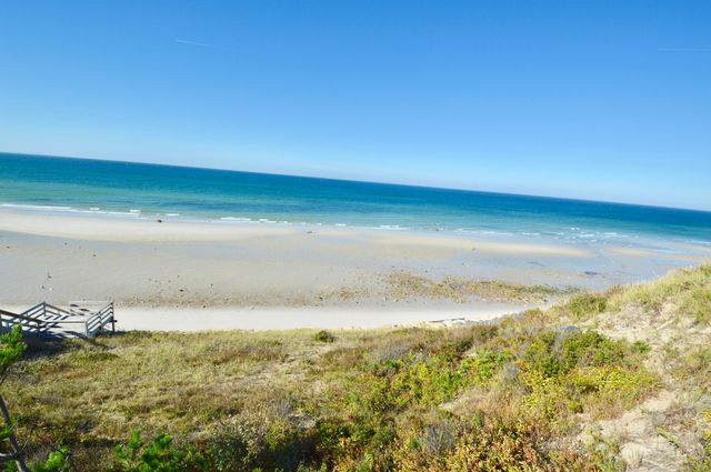 a view of a balcony with wooden floor and fence