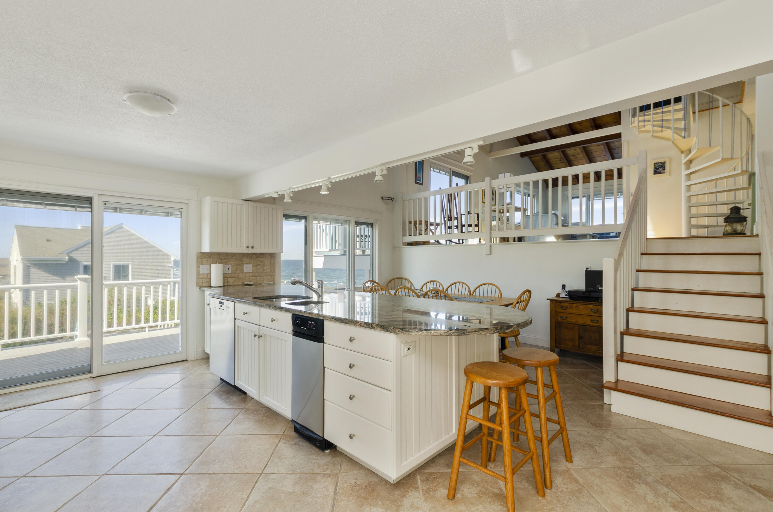 96 Shore Drive Dennis, MA 02638 - Photo 5 of 37 a kitchen with stainless steel appliances kitchen island granite countertop a sink and cabinets