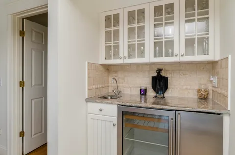a kitchen with granite countertop a sink and cabinets