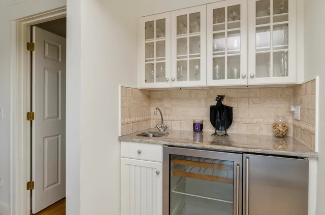 a kitchen with granite countertop a sink and cabinets