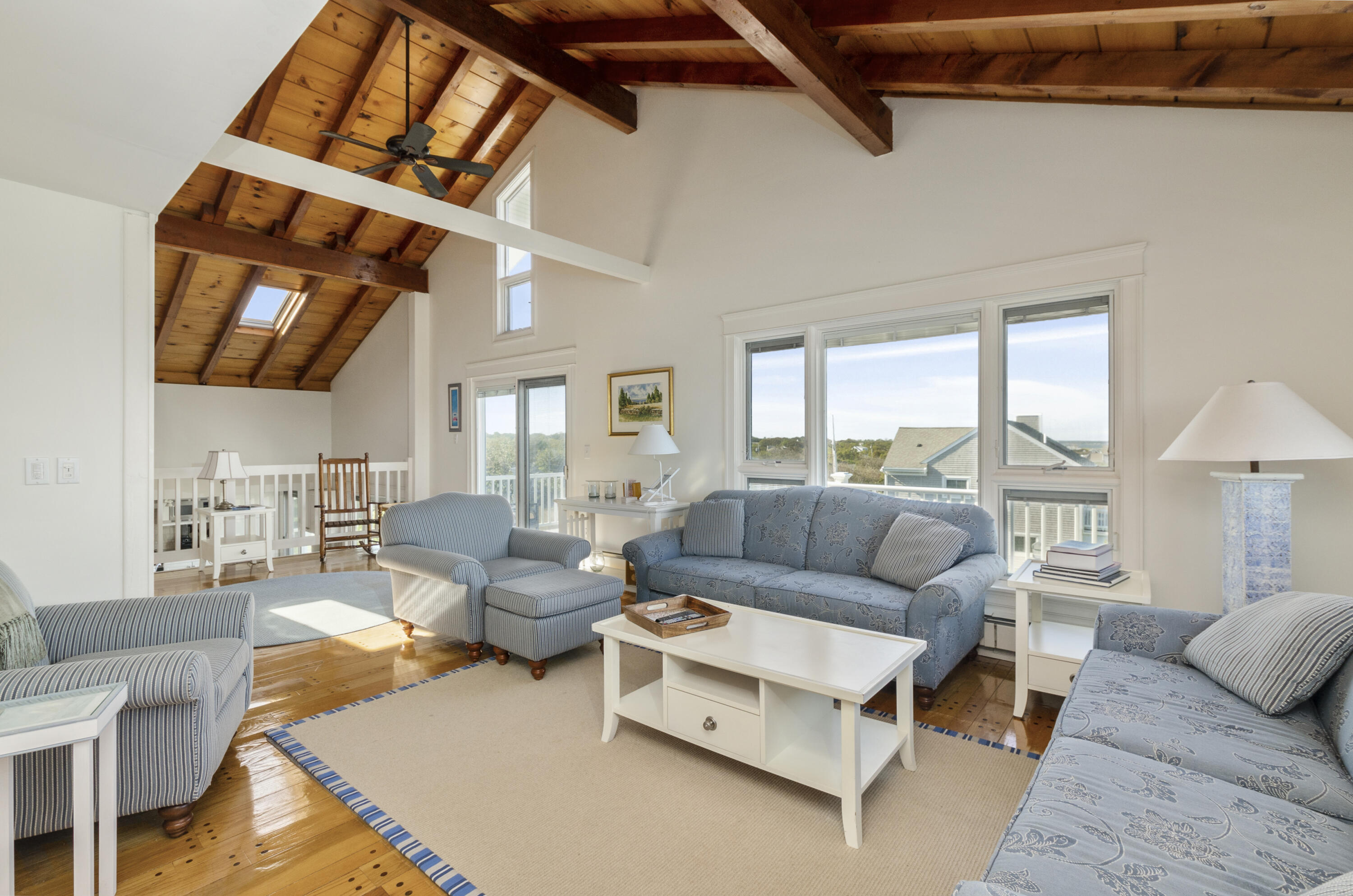 96 Shore Drive Dennis, MA 02638 - Photo 9 of 37 a living room with furniture a ceiling fan and a rug
