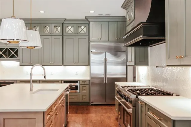 a bathroom with a granite countertop sink a toilet and shower