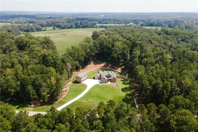 a living room with furniture a fireplace and a floor to ceiling window