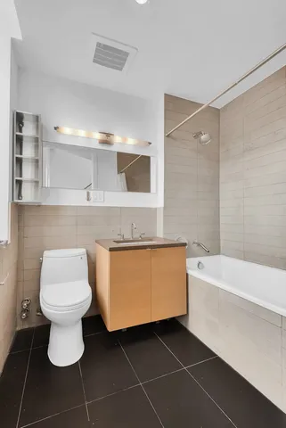 a bathroom with a sink a toilet and bathtub