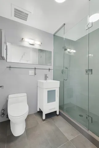 a bathroom with a toilet sink and shower