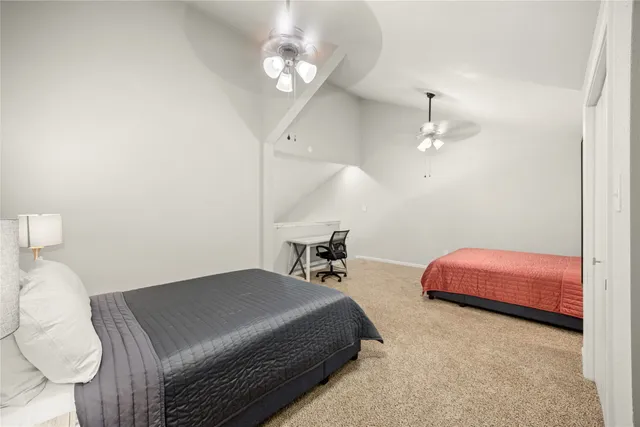 a bedroom with bed and a chandelier