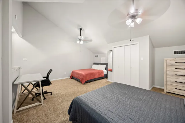 a bedroom with a bed a table and chair