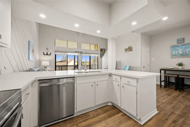 a kitchen with sink cabinets and wooden floor