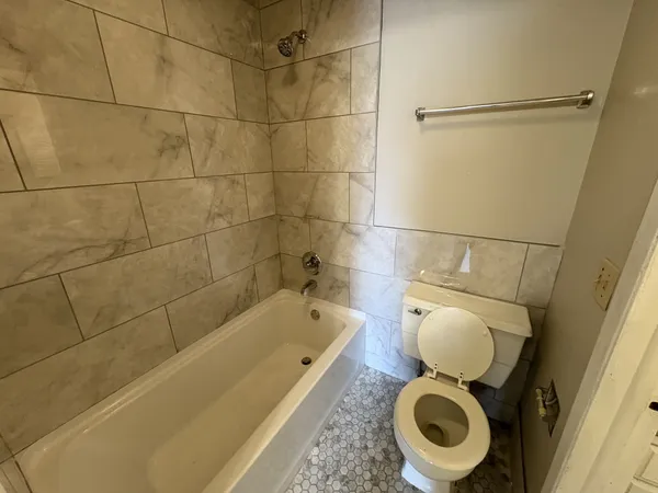 a bathroom with a toilet and a shower