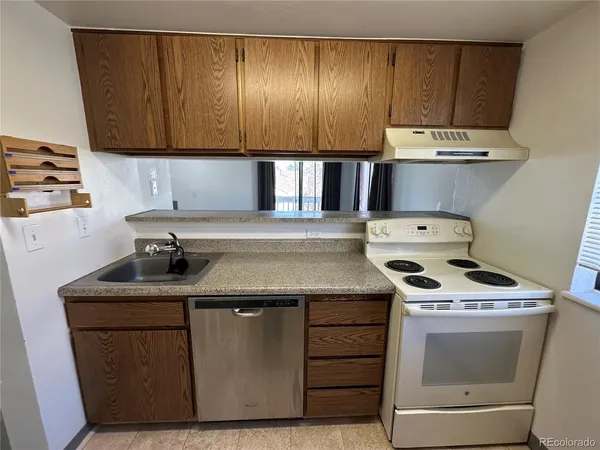 a kitchen with a stove and a sink